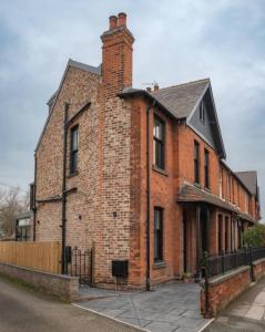 an old brick building with a chimney on a street at Escape 2 Unwind At The Parade, Accommodates 10 in York
