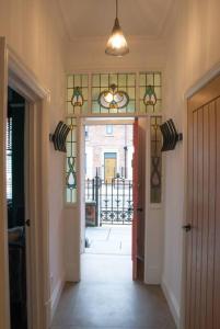 a hallway with a door and a glass window at Escape 2 Unwind At The Parade, Accommodates 10 in York