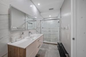 a white bathroom with a sink and a shower at Large Home Wking Bed By Pmi Unit Bh in Fort Lauderdale +64 photos