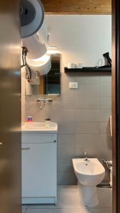 a bathroom with a white toilet and a sink at La Tulè in Popoli +42 photos