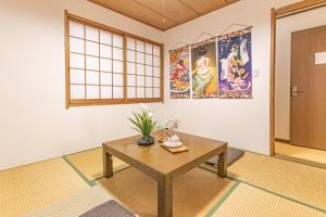 a room with a table with flowers on it at TokyoTokyo in Wada