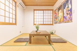 a room with a table on a rug at TokyoTokyo in Wada