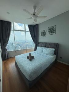 a bedroom with a bed with a ceiling fan at Nest In The Sky in Kuala Lumpur +5 photos