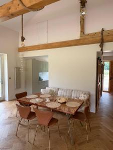 a dining room with a wooden table and chairs at Kryształowy Domek 
