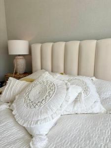 a white bed with a white comforter on it at Kryształowy Domek  +16 photos