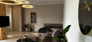 a bedroom with a bed and a living room at Loft N 39 - ekskluzywny apartament pod Zamkiem w Mosznej in Moszna