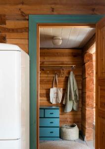 a closet with wooden walls and a blue cabinet at Cottage with sauna, in the heart of the Tammisaari in Tammisaari