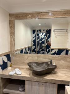 a bathroom with a sink and a large mirror at Taormina Seaview - Luxury Apartment in Taormina in Taormina