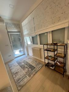 a living room with a book shelf and a window at BASC Modern 2 in Sarajevo
