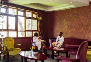 two people sitting on a couch in a waiting room at Enashipai Resort & Spa in Naivasha +71 photos