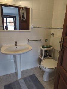a bathroom with a sink and a toilet at Casa do Canto Obidos in Amoreira +5 photos