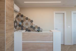 a kitchen with a counter and a wall with a sculpture at Residence Mirage in Caselle Torinese +39 photos