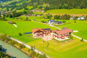 an aerial view of a large house on a green field at Appartement Achenhof in Bad Hofgastein