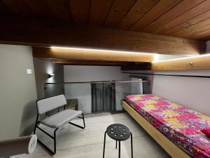 a small bedroom with a bed and a chair at La Tulè in Popoli