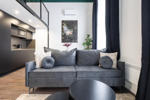 a living room with a gray couch and a table at E41 - Trendy Boutique Apartments - Prime Spot by BQA in Budapest