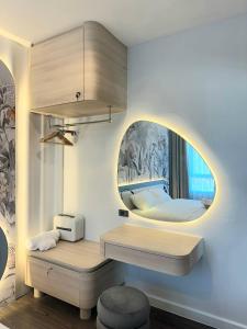 a room with a bedroom with a bed and a mirror at Nature retreat courtyard khaoyai เนเจอร์รีทรีท คอร์ดยาร์ดเขาใหญ่ in Mu Si