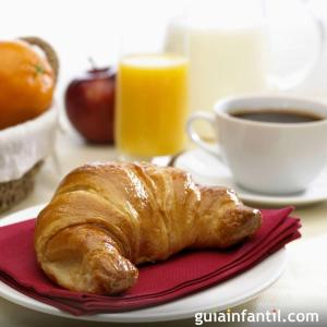 a plate with a croissant and a cup of coffee at Les vignobles d'Alsace in Wintzenheim