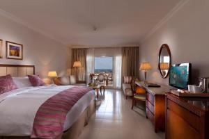 a hotel room with a large bed and a living room at Baron Palace Sahl Hasheesh in Hurghada