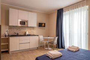a kitchen with a table and a counter top at Residence Mirage in Caselle Torinese