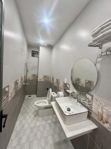 a bathroom with a toilet and a sink and a mirror at Phụng Hoàng Vũ in Bạc Liêu +35 photos