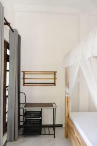 a room with a bed and a table in it at Slip Villa in Ahangama +4 photos