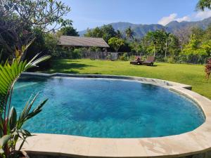 a large swimming pool in a yard at Kalkun Villa Amed in Amed