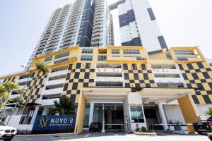 a building in front of a tall building at Novo 8 Premier Suites Melaka in Kampong Tambak