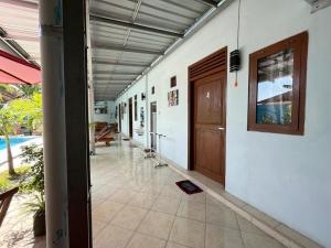 an empty hallway of a house with a door at Capital O 92615 Villa Utama D'alas Purwo in Ringinpintu