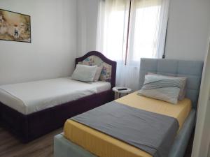 a bedroom with two beds and a window at Super Leisure Vila-Plazhi San Pietro, Gjiri i Lalezit in Lalzit Bay +26 photos
