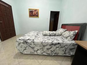 a bedroom with a bed and a door and a door at Capital O 92615 Villa Utama D'alas Purwo in Ringinpintu +30 photos