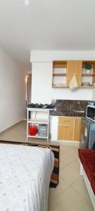 a small kitchen with a bed in a room at Studio solace kitisuru in Nairobi