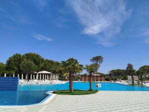 a swimming pool with palm trees in the middle at Super Leisure Vila-Plazhi San Pietro, Gjiri i Lalezit in Lalzit Bay