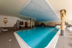 a large blue swimming pool in a hotel room at Apartments Sunseit'n in Sesto