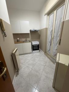 a small kitchen with a sink and a stove at Palazzo SantAntonio Apartament in Naples +24 photos