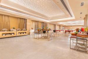a large banquet hall with tables and chairs at Sarovar Premiere Alwar in Alwar