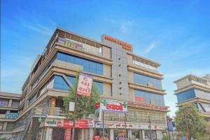 a tall building with signs in front of it at Hotel RK in Ahmedabad