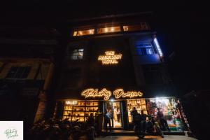 a building with a sign that reads the amethyst hotel at Amarjeet Hotel in Kurseong