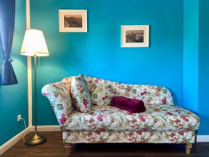 a living room with a couch with a pillow on it at Landhaus Waltersdorf - Pool & Wellness in Bad Schandau