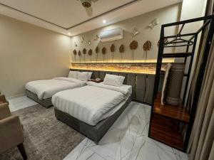 a hotel room with two beds and a staircase at The Luxe Nook in Islamabad