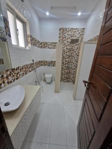 a bathroom with a sink and a toilet at The Luxe Nook in Islamabad