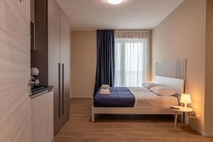 a bedroom with a bed and a window at Residence Mirage in Caselle Torinese