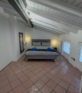 a bedroom with a bed in a white room at A Casa di Paola in Sirmione