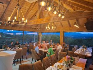 a group of people sitting at tables in a restaurant at Seosko domacinstvo Nedic in Valjevo