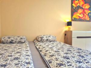 two beds sitting next to each other in a room at Nida Amber in Nida