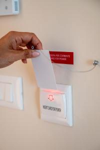 a person holding a piece of paper in front of a box at Residence Mirage in Caselle Torinese