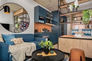 a living room with a blue couch and a table at Stylish Sea Point Apartment in Cape Town