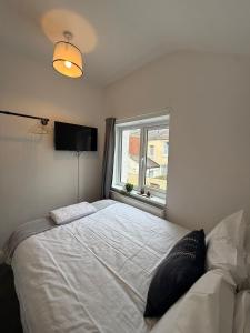 a bedroom with a large bed and a window at Charles Street House in Redcar
