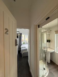 a bathroom with a glass shower and a sink at Charles Street House in Redcar