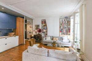 a living room with a couch and a table at Spacious apartment near the Villette in Paris