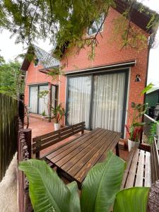 a wooden bench sitting in front of a house at Hoàng Gia Villa in Phan Rang–Tháp Chàm